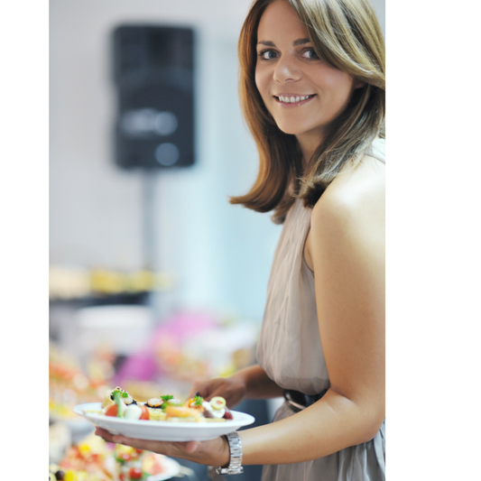 Young brunette samples the buffet at a banquet hall