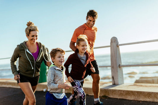a family joggin down a pier