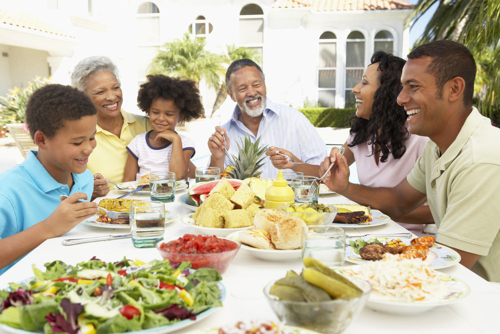 Grandparents and parents enjoy alfresco meal with children