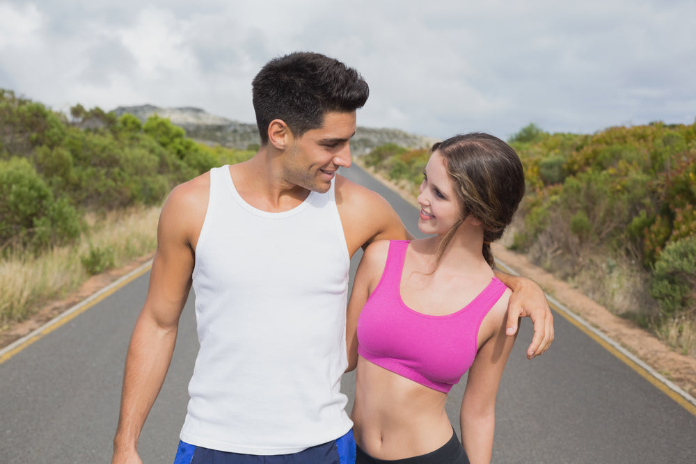 Fit young couple embrace after a run