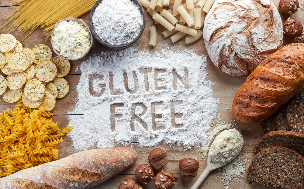 different kinds of bread arranged around flour that has the words gluten free written into it