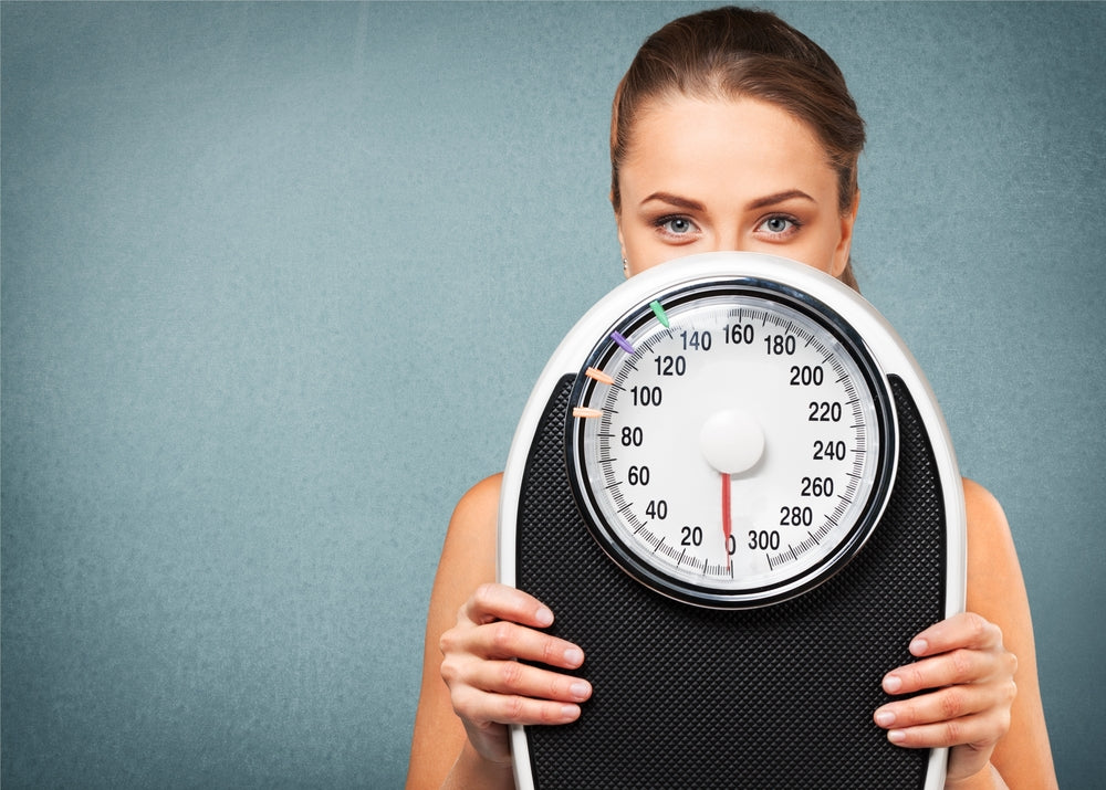 woman holding a scale