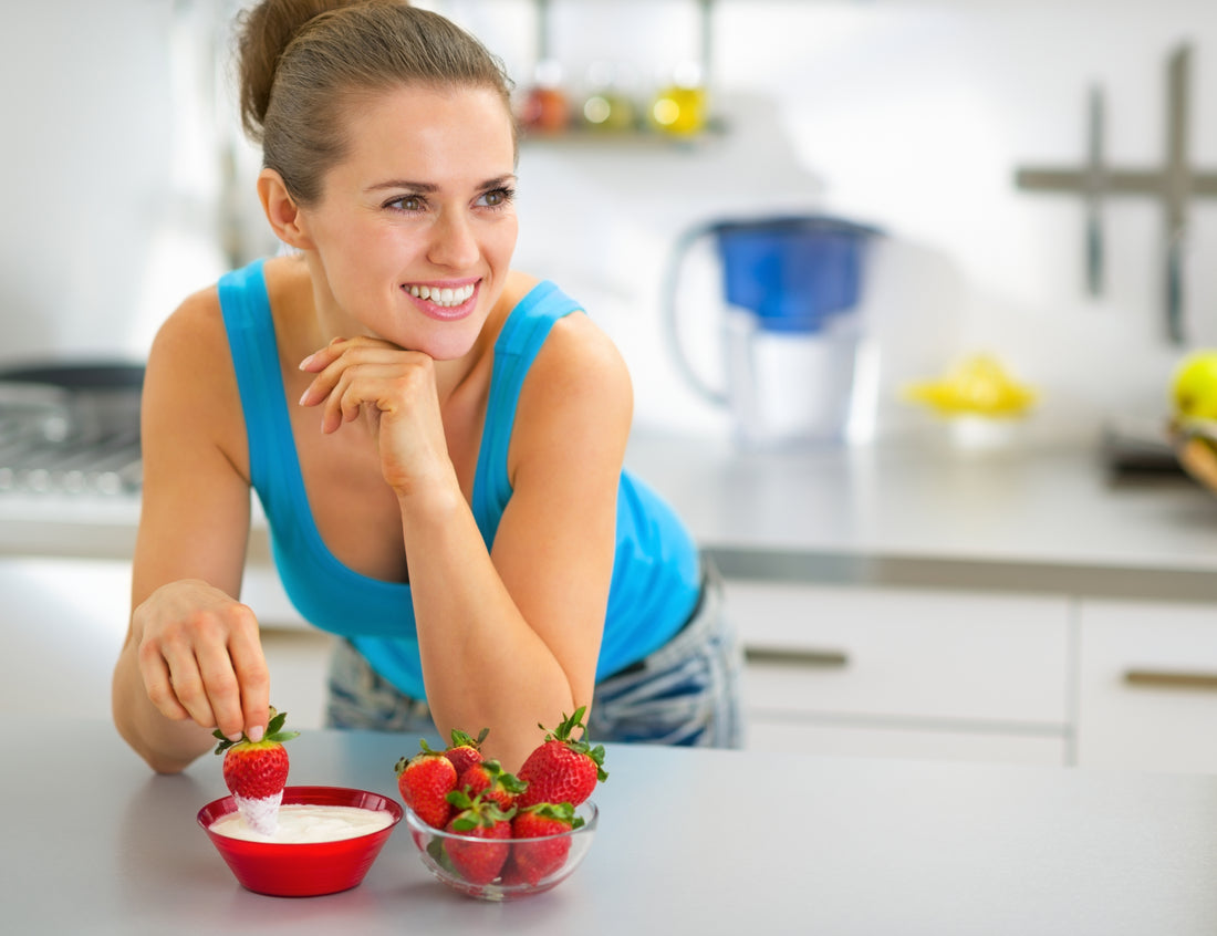 woman eating strawberries with cream