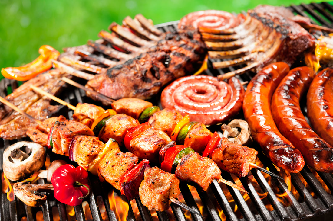 food (kababas, saugage, ribs) on a grill
